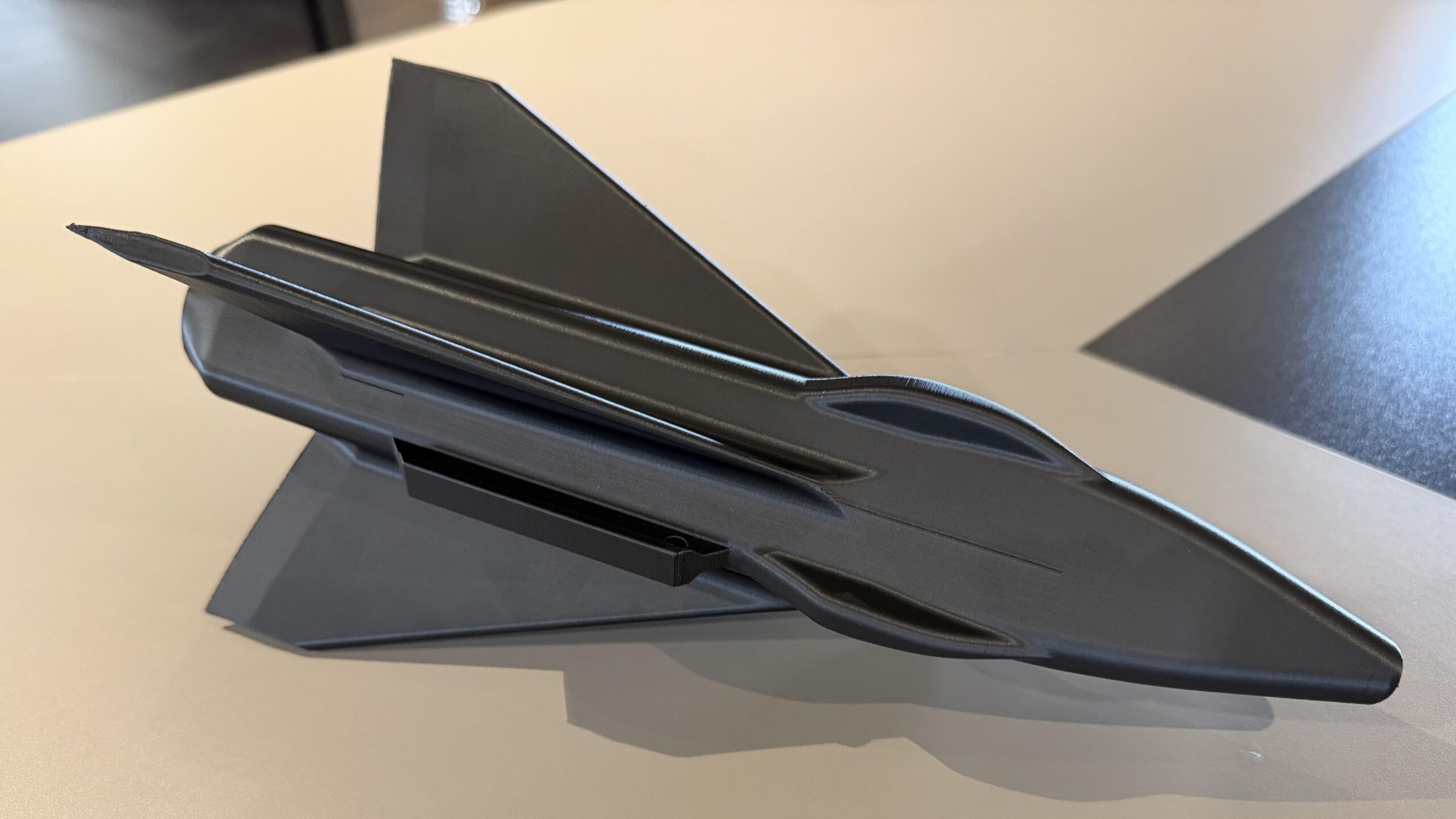 A 3D-printed black delta-wing jet model in Carbon5D with a smooth as-printed finish