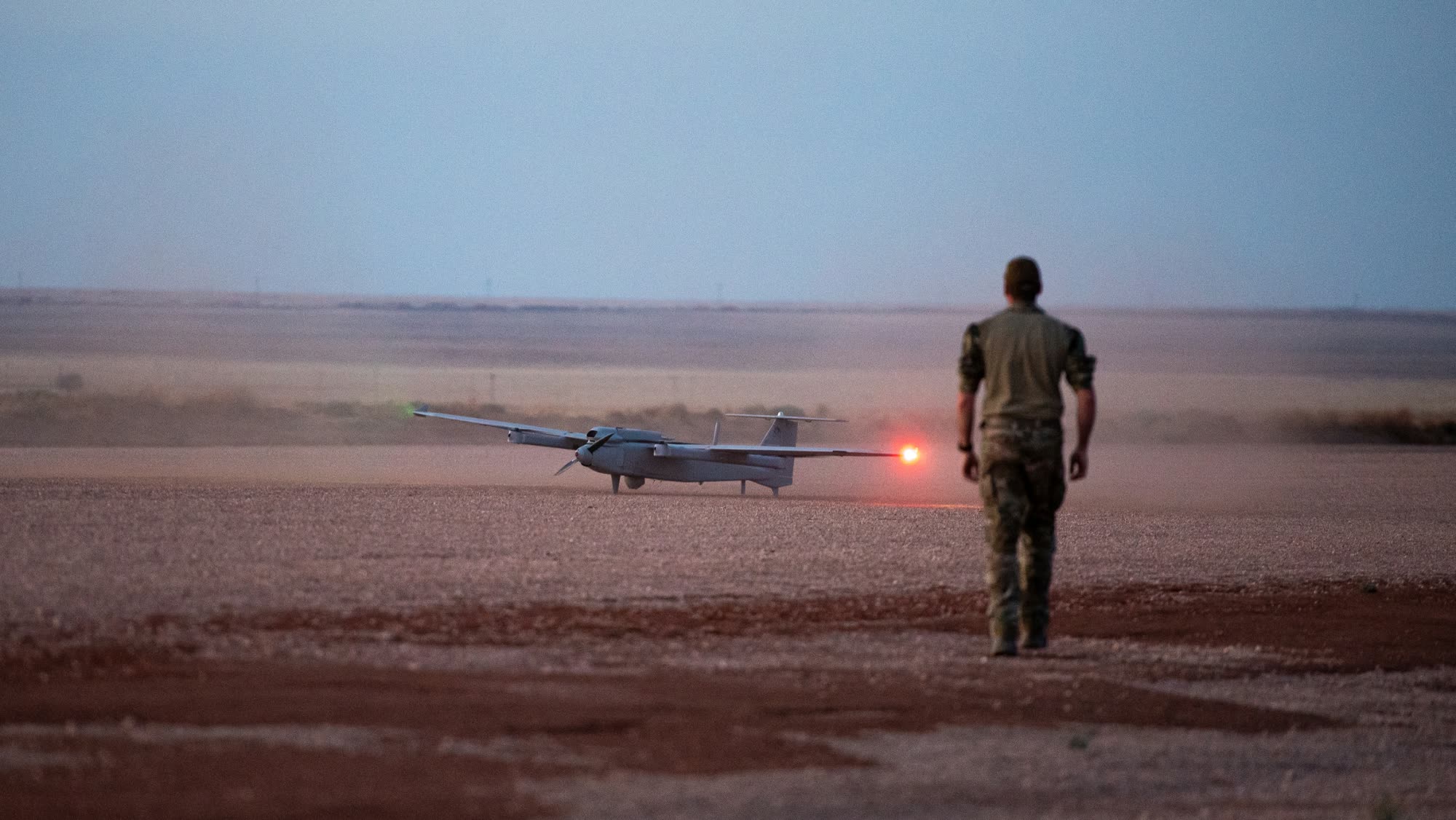 UAV at dusk on a desert strip with Aveo DroneV navigation lights lit