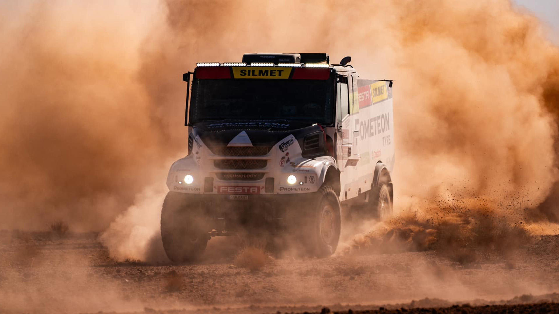Prometeon Dakar rally truck charging head-on through the desert