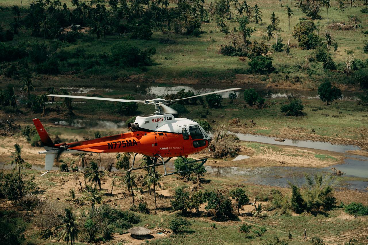 Mercy Air helicopter N775MA flying over flooded terrain
