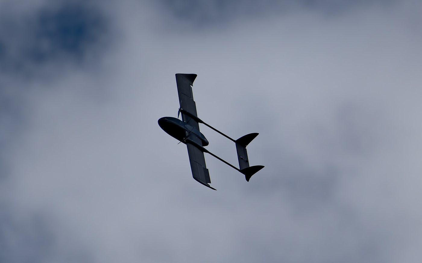 Aveo AirWing F-150 banking against an overcast sky