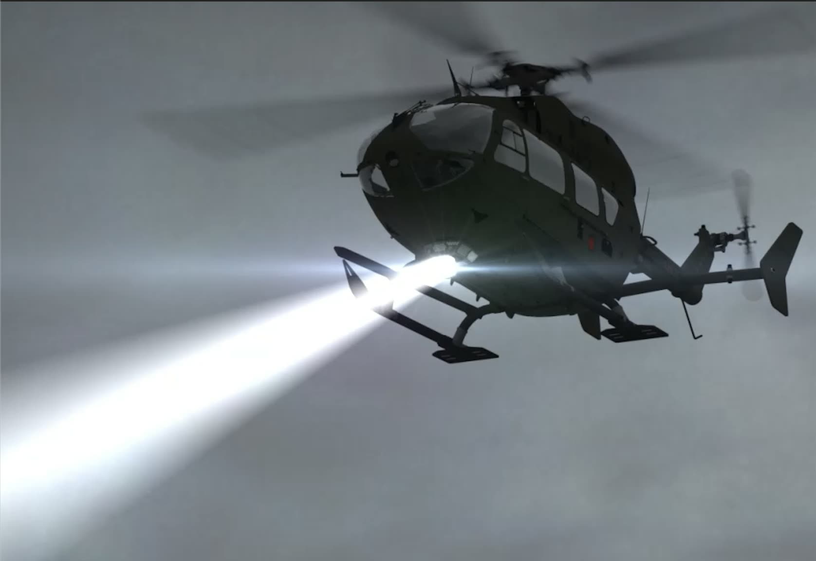 Military helicopter projecting a searchlight beam